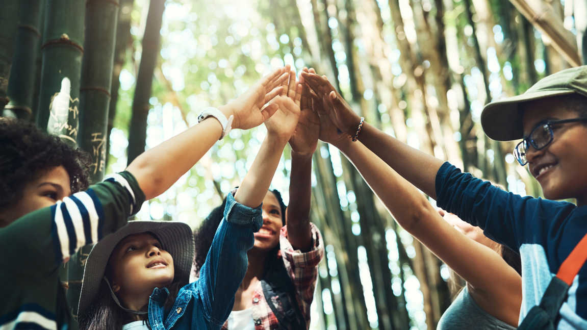 Shot Of A Group Of Teenagers Giving Each Other